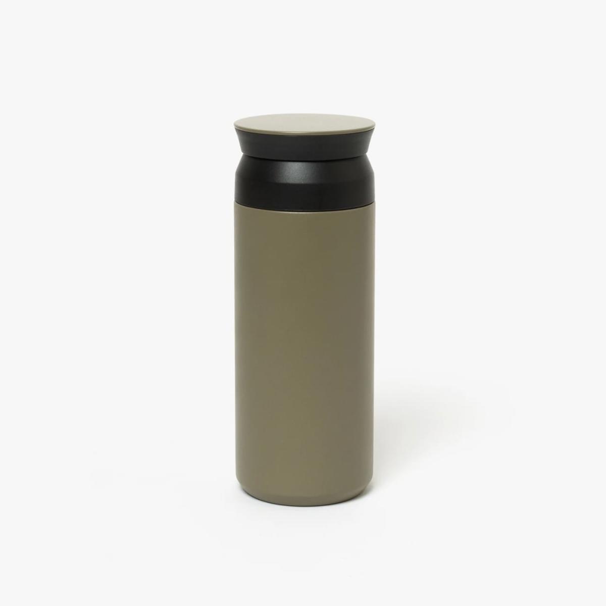 Tall slender porcelain bottle with natural clay textured body and cork stopper.